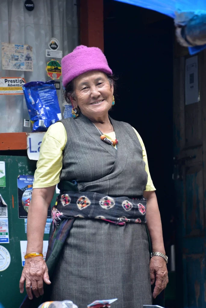 Close-up portrait of a Tamang woman in traditional dress, captured along the Langtang Valley Trek in Nepal, symbolizing cultural richness and heritage.